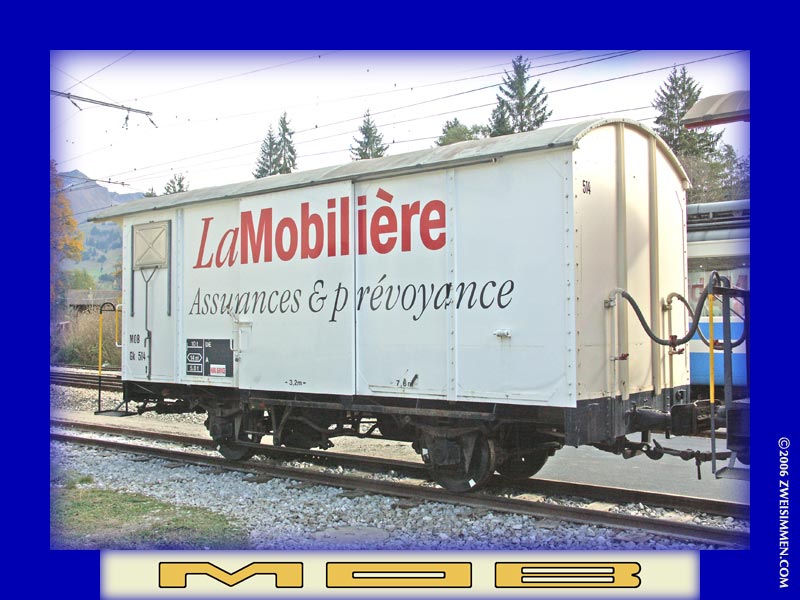 Gk514: MOB advertising boxcar 'La Mobilière, LH & rear, at Zweisimmen, October 21, 2005