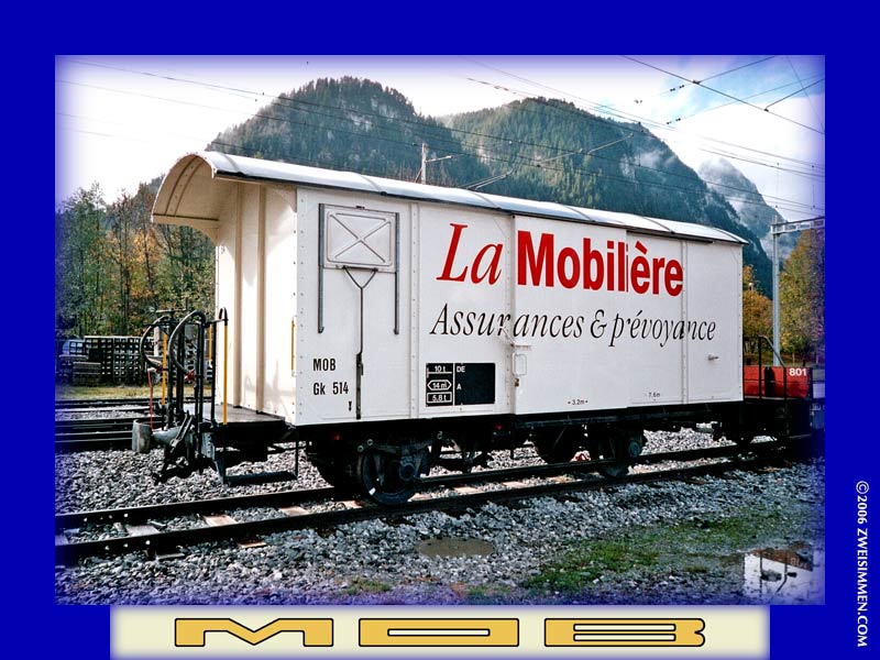 Gk514: MOB advertising boxcar 'La Mobilière, LH & front, at Zweisimmen, October 21, 2005